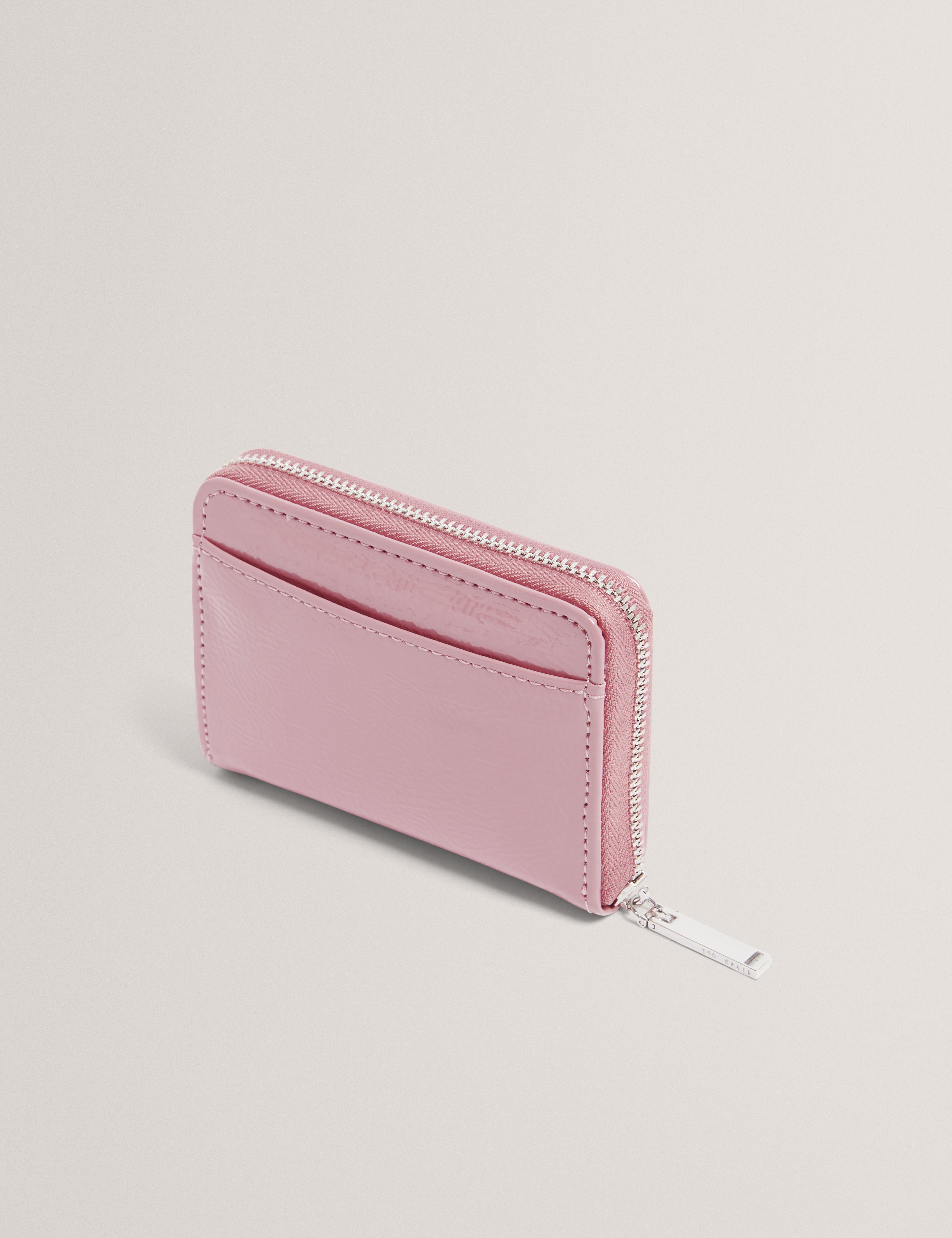 محفظة كريني كرينكل صغيرة بسحاب حولها باللون الوردي