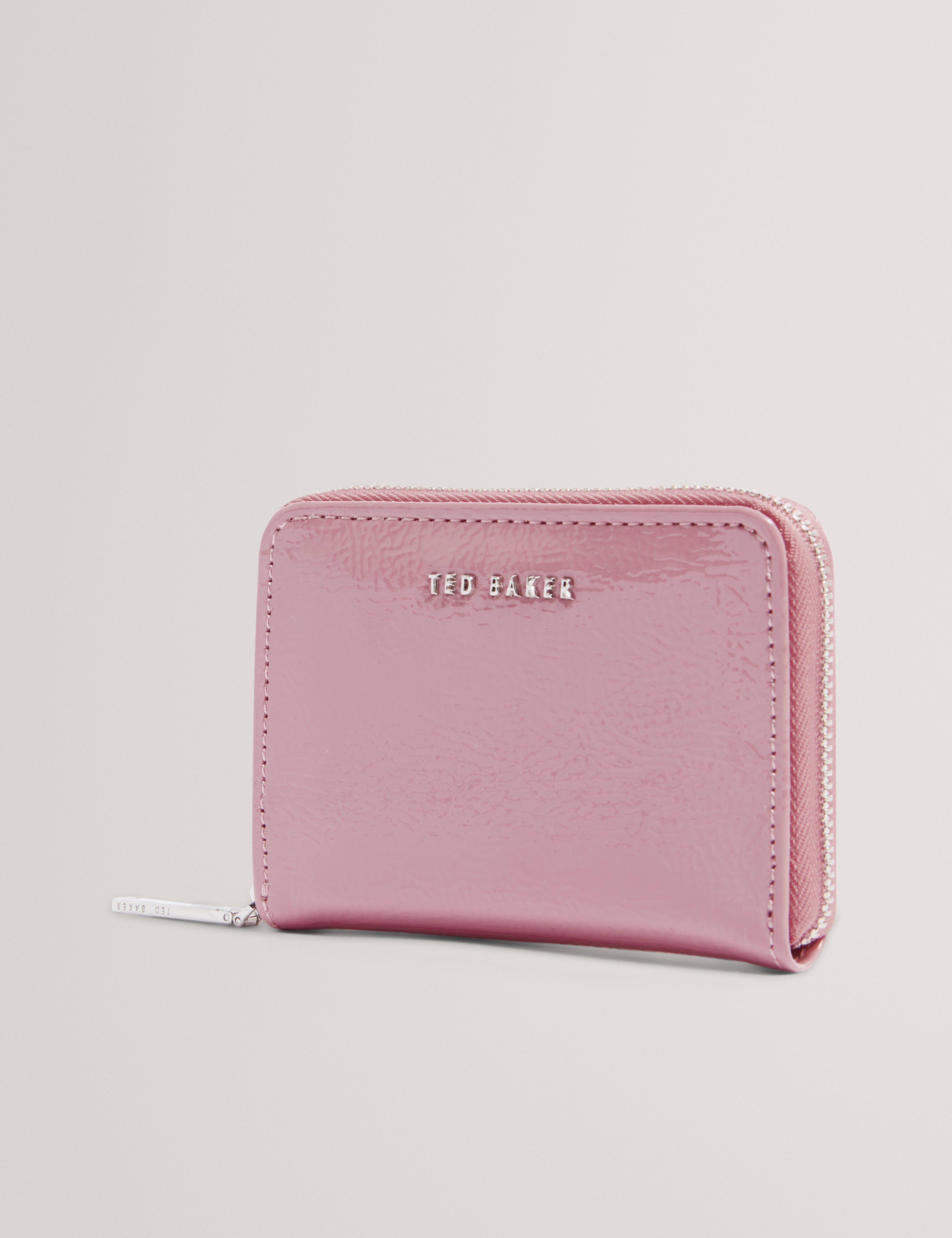 محفظة كريني كرينكل صغيرة بسحاب حولها باللون الوردي